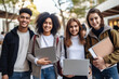 © FutureStock - Group of smiling friendly multiethnic students standing outdoors near university building. Students resting between lectures and making group photo in park.