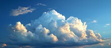 A Spectacular Natural Landscape With A Massive White Cumulus Cloud Floating In The Blue Sky, Creating A Breathtaking Meteorological Phenomenon.