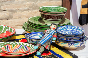 Wall Mural - Multicolored uzbek porcelain and gift puppet. Street market display. Khiva, Uzbekistan