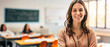 a image of a portrait of a beautiful young female school teacher standing in the classroom, with blurred background and empty copy space