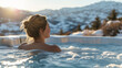 A woman enjoys a hot bath in a pool at a spa retreat with steam around her, against a backdrop of snowy mountains in winter. Ai generative