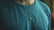 a blue T-shirt with a silver ring and a pearl on the hem 