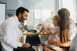 © dsheremeta - The pediatrician establishes contact, trust and a good relationship with the child. Happy little girl, mother and family doctor playing fun game with toy and stethoscope