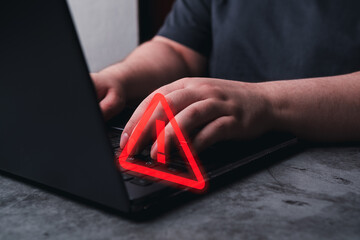 Woman use laptop with hologram warning sign for notification error. Programmer, developer and maintenance system concept. Scam virus attack. Security protection.