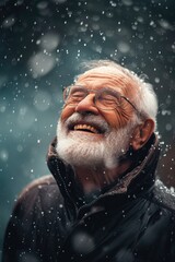 Old happy man is smiling under the rain. He feels wonder and joy