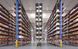 Rows of warehouse metal racks with gods. Modern hi storage hall.