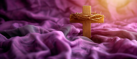 Wood cross and a crown of thorns over soft purple fabric for easter. Catholicism symbol.