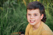 © Austockphoto - Portrait of happy boy wearing yellow shirt in Australian country bush setting