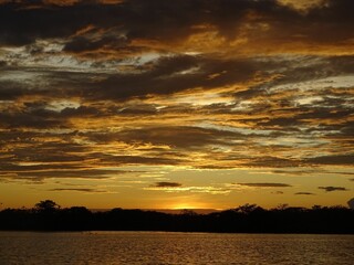 Canvas Print - Sunset over lake with clouds