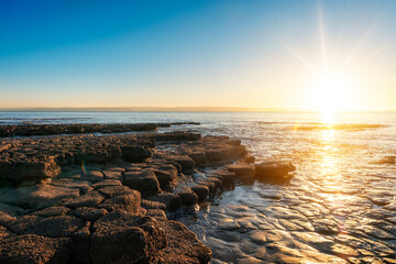 Wall Mural - beautiful sun rise over the rocky coast in winter