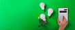 incandescent lamp and hand hold led lamps against on isolated green background. Energy efficiency concept. Flat lay. Concept ecology, save planet earth, idea, save energy, economy, saving. Earth day..