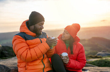 Wall Mural - happy couple in love walking along the countryside at the sunset, taking selfies, streaming. Love, hiking and active lifestyle concept