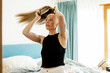 © Johnér - Woman suffering from cancer wearing wig while standing in bedroom