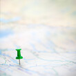 © Brian Jackson - Green thumbtack marking and showing destination location point on map background with copy space