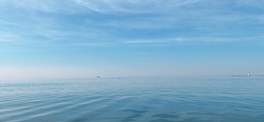 Wall Mural - Tranquil minimalistic ocean with the backdrop of clear blue sky