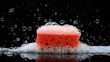 soap foam and red sponge in foam with bubbles isolated on black background