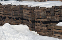 Stacks Of Old Vintage Wooden Railway Sleepers Surrounded By Snow