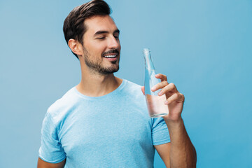 Wall Mural - Happy man water healthy portrait bottle attractive smile studio sport lifestyle t-shirt drink