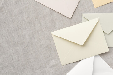 Wall Mural - beige and white envelopes are randomly placed on a gray tablecloth, leaving a copy space on the left