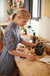 © Bergen/peopleimages.com - Cooking, woman and mortar with grind in a home with diet, nutrition and healthy food with pestle. Kitchen, bowl and happy from organic and vegan lunch with mushroom and wood board with wellness