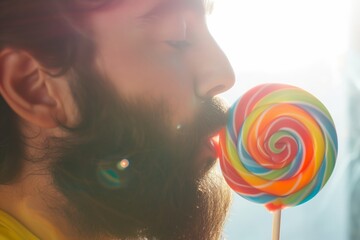 Poster - man with beard licking a colorful spiral lollipop in a bright setting