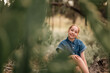 © Austockphoto - Portrait of pre-teen girl sitting on log in natural setting with big smile