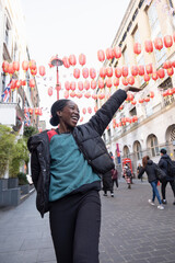 Wall Mural - Portrait of happy young woman in Chinatown