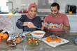 © Cultura Creative - Mid adult couple eating meal at home