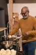 © Cultura Creative - Senior man preparing food in kitchen