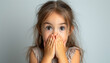 © Thijs - Cute cheerful toddler girl with straight hair in casual clothes covering mouth with hand while looking away smiling, shocked on white isolated background