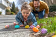 The baby girl crawls on the ground to hunt Easter eggs