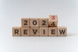2023 business and customer review for business strategic planning in the next year 2024. Flipping of 2023 to 2024 on wooden blocks. End of the year business concept.