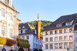 administration building German city of Heidelberg with long national flag, street of historic building, beautiful facade ancient house European German architecture