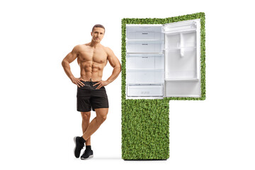 Poster - Fitness male model leaning on a green eco friendly fridge