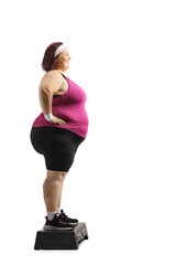 Sticker - Full length profile shot of a corpulent woman standing on a stepper