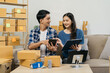 © NINENII - Couple start up small business owner at workplace. small business entrepreneur SME or freelance asian woman working with box at home.