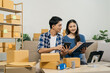 © NINENII - Couple start up small business owner at workplace. small business entrepreneur SME or freelance asian woman working with box at home.