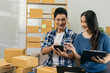© NINENII - Couple start up small business owner at workplace. small business entrepreneur SME or freelance asian woman working with box at home.