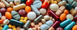 © chayantorn - close-up of various pharmaceutical pills and capsules spread out, highlighting the range of modern medicine