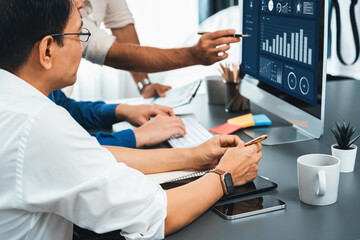Data analysts team working analyzing business intelligence BI dashboard display on laptop to analyze financial, trend, and marketing data. BI technology and data analysis for business success. Prudent