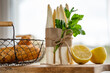 Fresh white asparagus and potatoes. Spring vegetables on wooden cutting board. Ingredients for a healthy menu. Kitchen scene for the seasonal gastronomy. Close-up with short depth of field.