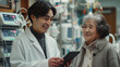 © Krisana - Handsome asian doctor with tablet converses cheerfully with elderly dialysis patient in hospital, amidst dialysis equipment.generative ai