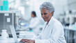 © HelenP - mature female scientist is working on a laptop in a laboratory