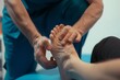 © Adito - close up physical therapist is massaging a patient's foot
