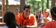 © Brian - Summer camp concept with camp counselor and kids camping in the woods
