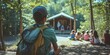© Brian - Summer camp concept with camp counselor and kids camping in the woods