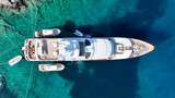 Fototapeta Na drzwi - Aerial drone top down photo with copy space of luxury yacht anchored in tropical exotic island with crystal clear turquoise sea