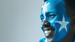 Somalia flag face paint, Close-up of a person's face, symbolizing patriotism or sports fandom.
