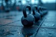 A close-up of kettlebells arranged by weight on a gym floor, with the focus on the textured grips and the potential for strength training they represent.