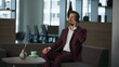© stockbusters - Businessman making call office. Smiling financial manager talk mobile phone
